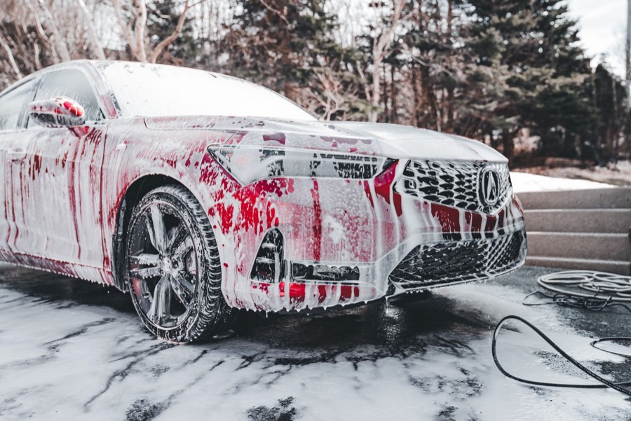 Car covered in wash foam outdoors