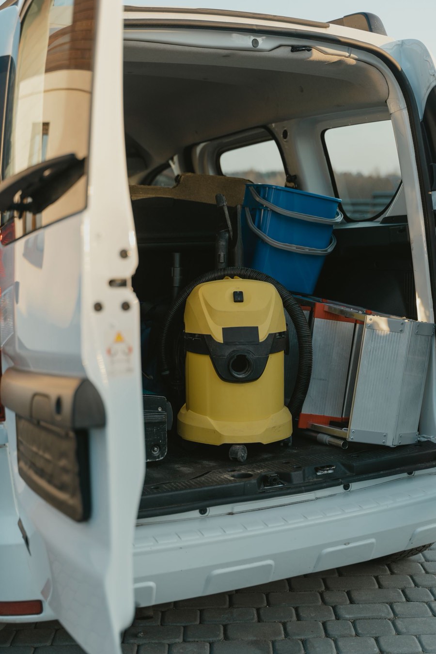 Service van loaded with detailing equipment, rear doors open