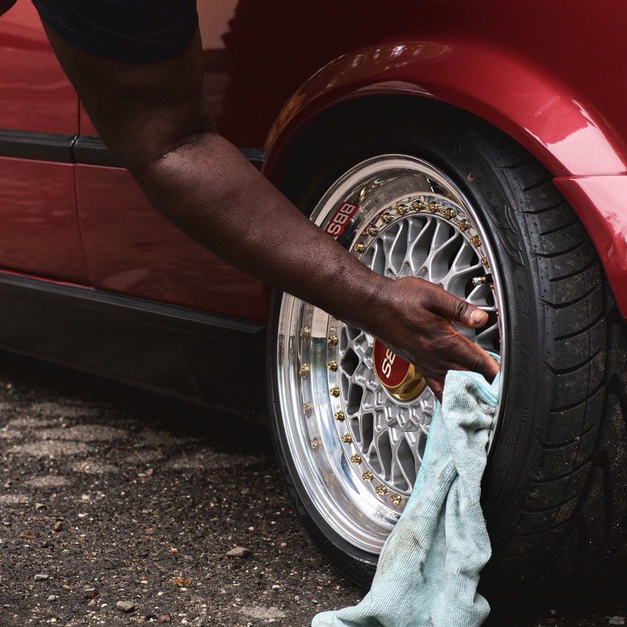 Hand drying a polished wheel with a microfiber towel